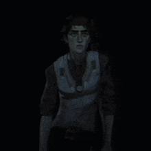 a man in a suit and tie is standing in the dark in a dark room .