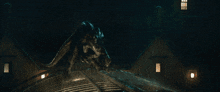 a monster is walking across a bridge with a building in the background