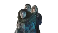 a man and two women are hugging each other in a dark room with a white background