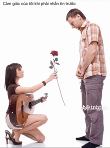 a woman is kneeling down holding a rose and a guitar