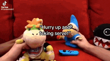 a person is holding a stuffed animal next to a nintendo switch and a nintendo switch controller .