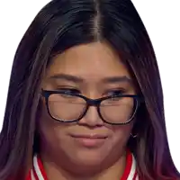 a close up of a woman wearing glasses and a red and white shirt