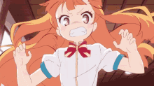 a girl with long orange hair is making a funny face with her hands