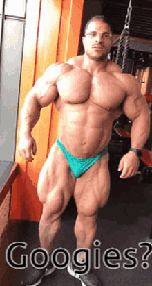 a muscular man in a green bikini is standing in front of a window with the words googlies written below him