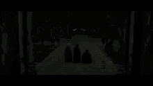 a group of people are walking down a set of stairs in a dark room