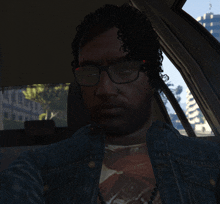 a man wearing glasses and a denim jacket is sitting in the back seat of a car