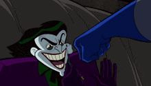 a cartoon of the joker being punched by another character