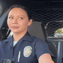 a female police officer is sitting in a car