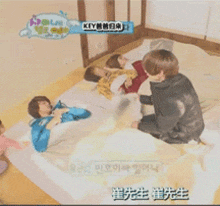 a group of people laying on a bed with the word key on the bottom