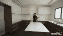 a woman is standing in a kitchen with the words made in animotica on the bottom