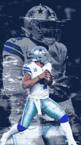 a cowboys football player is holding a ball in his hand