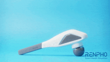 a massage gun is displayed on a blue surface