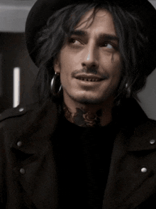 a man with a tattoo on his neck is wearing a hat