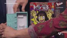 a person is holding a toy box that says ' tokyo ' on it