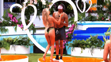 a man and a woman are dancing in front of a sign that says peacock