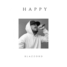 a black and white photo of a man singing into a microphone with the words happy blazzard