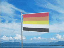 a rainbow flag is flying in the wind