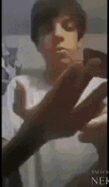 a person 's hand is reaching out towards another person 's face in a blurry photo that says news