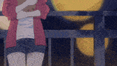 a girl in shorts and a red jacket stands on a balcony