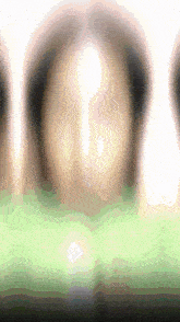a blurred image of a person 's face with a light shining through it