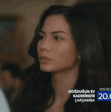 a close up of a woman 's face with the words dogdugun ev kaderindir carsamba on the bottom of the screen .