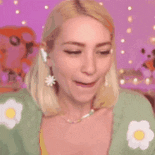 a woman wearing headphones and a necklace is making a funny face .