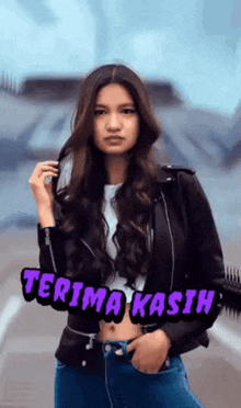 a woman in a leather jacket is standing in front of a sign that says " terima kasih "