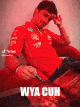 a man wearing a red shirt that says vgw play on it