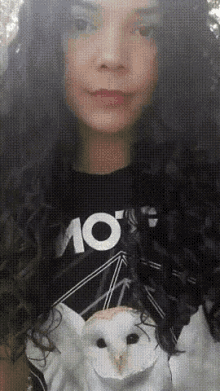 a girl with curly hair is wearing a shirt that says ao