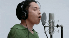 a man is singing into a sony microphone