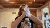 a woman is washing her hands with a bottle of water in front of her .