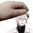 a hand is putting a piece of paper on top of a man 's head .