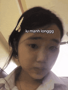 a girl with a clip in her hair has the word iu on her forehead