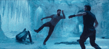 a man kicking another man in the face in a room with nandmoviefans.com written on the bottom