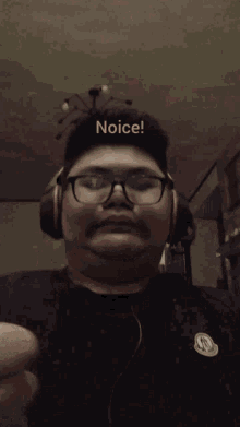 a man wearing glasses and headphones is giving a thumbs up with the word noice written above him