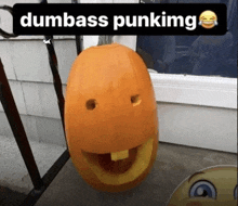 a picture of a pumpkin with a face carved into it and the words dumbass punking above it