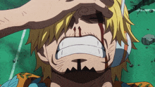 a close up of a man 's face with blood coming out of it