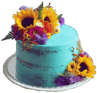 a blue cake decorated with sunflowers and other flowers