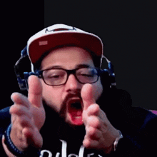 a man wearing glasses and headphones is making a funny face with his mouth open