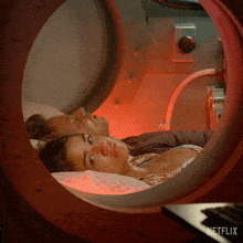 a man and a woman are laying in a circle with a netflix logo in the corner