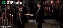 a man and a woman are dancing at a party .