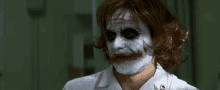 a woman in a nurse 's uniform is wearing a joker mask and says hi .