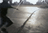a blurry picture of a person riding a skateboard on a road