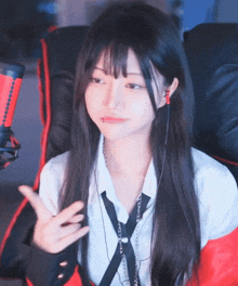 a girl with long hair and ear buds is sitting in a chair