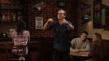 a group of people are dancing in a bar with a sign that says reserved parking