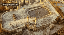 an aerial view of a large mosque with the words kulfyapp.com at the top