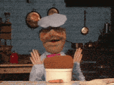 a cartoon chef is holding a piece of bread in his hand