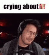 a man wearing headphones is crying with the words crying about below him