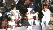 a group of people are dancing in front of a crowd with a watermark that says rtbd.gif