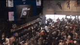 a large crowd of people are gathered in a bar with a sign that says ' u.s. army ' on it